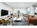 Spacious living room featuring large windows with city views, comfortable seating and contemporary design at 110 N Corcoran St # 2502, Durham, NC 27701