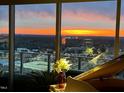 Enjoy breathtaking city views from this elegant condo featuring floor-to-ceiling windows and a lovely orange sunset at 110 N Corcoran St # 2502, Durham, NC 27701