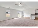 Bright living room features new carpet, large windows, and vaulted ceilings at 12 Crow Field St, Roxboro, NC 27574