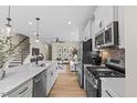 Open kitchen with stainless appliances overlooking the bright living room at 1259 Hammond Dr, Mebane, NC 27302