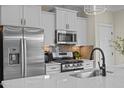Modern kitchen with stainless steel appliances, quartz countertops, and stylish backsplash at 1259 Hammond Dr, Mebane, NC 27302