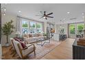 Bright living room featuring a plush sofa, stylish chairs, and large windows at 1259 Hammond Dr, Mebane, NC 27302