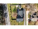 A top-down aerial view shows the home, roof, and fenced in yard at 1310 S 8Th St, Lillington, NC 27546