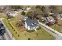 Beautiful aerial view shows property's spacious fenced yard, mature trees, and classic design at 1310 S 8Th St, Lillington, NC 27546