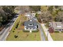 An elevated view showcasing a white home, neat landscaping, and a private driveway at 1310 S 8Th St, Lillington, NC 27546