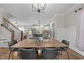 Elegant dining area with modern chandelier, hardwood floors, and open access to the living room at 1515 E Jones St, Raleigh, NC 27610