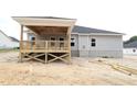 Back view of new home featuring a covered wood deck and gray vinyl siding at 1547 Pecan Drive # 31, Nashville, NC 27856
