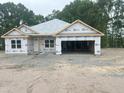 New construction shows a charming single-story home with a spacious two-car garage and a clean, modern design at 1565 Pecan Drive # 30, Nashville, NC 27856