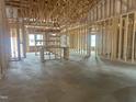 New construction framing reveals a home's open floor plan with exposed ceiling joists and ample natural light at 1565 Pecan Drive # 30, Nashville, NC 27856