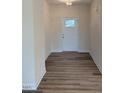 Inviting entryway featuring neutral walls and laminate wood flooring at 161 Jones Creek Ln, Lillington, NC 27546