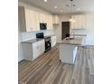 Modern kitchen with white cabinetry, granite countertops and a center island at 161 Jones Creek Ln, Lillington, NC 27546