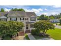 Charming two-story townhouse with a well-maintained front yard and inviting entrance with brick steps at 202 Wimbledon Ct, Clayton, NC 27520