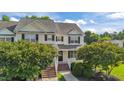 Inviting two-story townhome with a well-manicured lawn and brick-lined entryway, creating great curb appeal at 202 Wimbledon Ct, Clayton, NC 27520