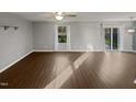 Bright living room with wood floors and sliding glass doors to the backyard at 2053 Alderman Way, Creedmoor, NC 27522