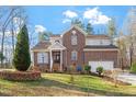 Charming brick two-story home with manicured lawn and attached two-car garage at 2053 Stillwood Dr, Youngsville, NC 27596