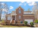 Charming brick two-story home with manicured lawn and attached two-car garage at 2053 Stillwood Dr, Youngsville, NC 27596