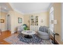 Cozy living room with armchairs, area rug, and built-in shelving for decor and storage at 2308 Carriage Oaks Dr, Raleigh, NC 27614