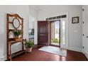 Bright and airy foyer featuring hardwood floors, coat rack and a view of the front door at 2554 Club Level Dr, Apex, NC 27523