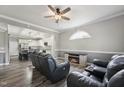 Open concept living room with hardwood floors, ceiling fan, and open view to the kitchen at 327F Bobbitt Rd, Clayton, NC 27520