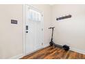Entryway with coat rack and scooter, featuring stylish wood-look flooring and a bright white door at 36 Labradoodle Ct, Garner, NC 27529