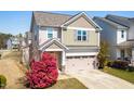 Two-story home with a two car garage, appealing curb appeal, and mature landscaping at 36 Labradoodle Ct, Garner, NC 27529