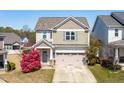 Attractive two-story home with a convenient two-car garage, accented by colorful landscaping and a welcoming entrance at 36 Labradoodle Ct, Garner, NC 27529