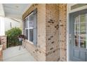 Charming covered front porch with brick siding at 401 Molina Ct, Rolesville, NC 27571