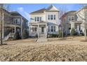 Charming two-story home with a welcoming porch and landscaped front yard on a sunny day at 416 Holding Creek Dr, Wake Forest, NC 27587