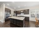 Spacious kitchen featuring a granite island, stainless steel appliances, and dark wood cabinets at 416 Holding Creek Dr, Wake Forest, NC 27587