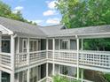 Condominium balconies with gray siding, white railings and trim at 4601 Timbermill Ct # 302, Raleigh, NC 27612