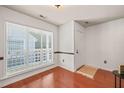 Bright living room with hardwood floors and large window with blinds at 4601 Timbermill Ct # 302, Raleigh, NC 27612
