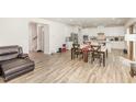 Open concept living and dining area with light wood floors and lots of natural light at 609 Embrun Run, Wendell, NC 27591
