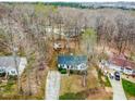 Aerial view of a one-story home showcasing its roof, spacious yard, and surrounding neighborhood at 6208 Silver Spring Ct, Willow Springs, NC 27592