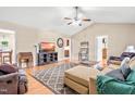 A cozy living room with wood floors, a ceiling fan, comfortable couches, and an inviting atmosphere at 6208 Silver Spring Ct, Willow Springs, NC 27592