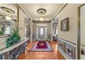 Elegant foyer with hardwood floors, decorative rug, and a stylish console table at 749 Hadrian Dr, Garner, NC 27529