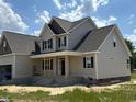 New home under construction featuring neutral siding and a covered front porch at 85 Prency Ln, Middlesex, NC 27557