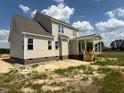 Rear view of a home under construction with a partially completed covered patio at 85 Prency Ln, Middlesex, NC 27557