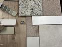 Home design selections featuring wood flooring, carpet, granite countertops, and neutral paint swatches at 85 Prency Ln, Middlesex, NC 27557