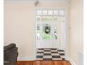 Bright foyer with a checkered floor, white trim, and a view of the front door at 904 Hidden Jewel Ln, Wake Forest, NC 27587