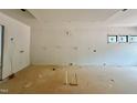 Open concept living area with white walls, recessed lighting, and large windows at 95 Cherry Bark Dr, Youngsville, NC 27596