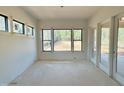 Bright sunroom with large windows providing abundant natural light and outdoor views at 95 Cherry Bark Dr, Youngsville, NC 27596