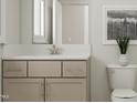 Bright bathroom featuring a modern vanity with a white countertop and neutral cabinets and walls at 300 Calvander Ln, Apex, NC 27539