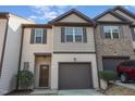 Charming townhome featuring a one-car garage, shutters, and a combination of siding and brick at 102 Bella Pl, Holly Springs, NC 27540