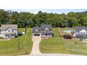Spacious property with fenced yard, mature trees, and a peek of the lake at 112 Roping Horn Way, Willow Springs, NC 27592