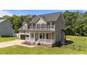 Attractive two-story home boasting a cozy front porch and attached two-car garage at 112 Roping Horn Way, Willow Springs, NC 27592