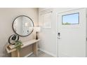 Bright entryway with stylish console table, round mirror, and a door with glass panel at 1169 Abbott St, Mebane, NC 27302