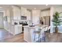 A stylish kitchen with white cabinets, a stainless steel appliances, a granite countertop, and a modern island at 1169 Abbott St, Mebane, NC 27302