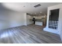 Bright open concept living room with wood floors, a staircase and direct access to the kitchen at 1255 Hammond Dr, Mebane, NC 27302