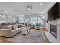 Inviting living room with fireplace, plantation shutters, hardwood flooring, and contemporary lighting at 129 Cofield Cir, Durham, NC 27707