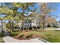 Beautiful gray home with black shutters, surrounded by lush landscaping and mature trees at 1300 Marshall Farm St, Wake Forest, NC 27587